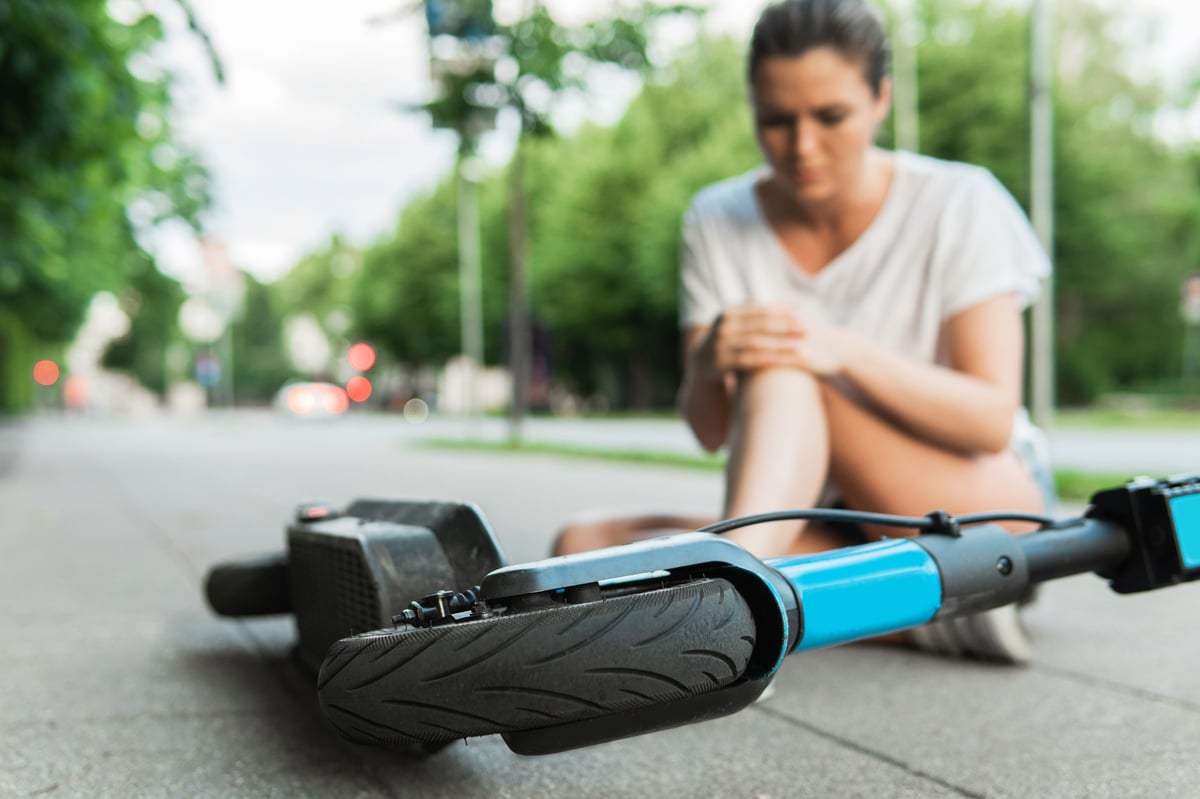Woman suffering from knee pain after e-scooter accident